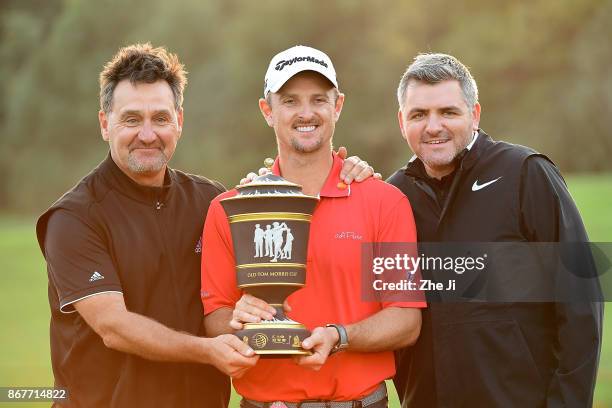 Justin Rose of England celebrates with the Old Tom Morris Cup and caddie Mark Fulcher and agent Paul McDonnell after finishing 14 under to win the...