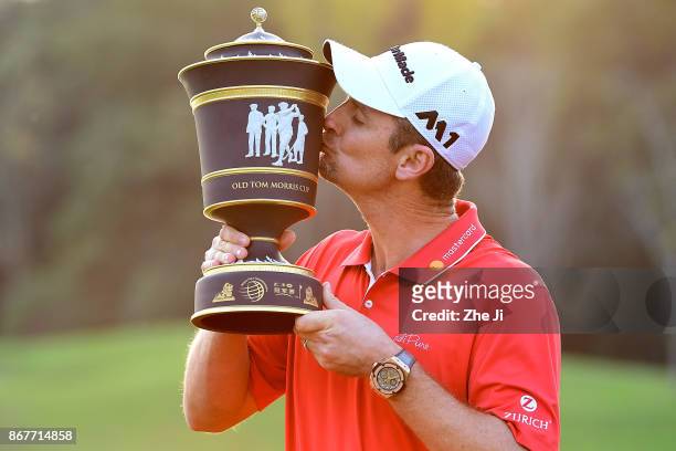 Justin Rose of England celebrates with the Old Tom Morris Cup after finishing 14 under to win the WGC - HSBC Champions at Sheshan International Golf...