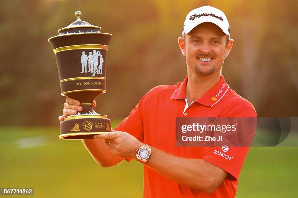 Justin Rose of England celebrates with the Old Tom Morris Cup after finishing 14 under to win the WGC - HSBC Champions at Sheshan International Golf...