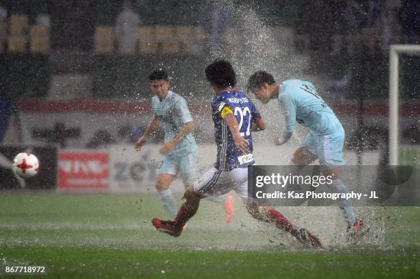 Masaya Matsumoto of Jubilo Iwata and Yuji Nakazawa of Yokohama F.Marinos compete for the ball during the J.League J1 match between Jubilo Iwata and...