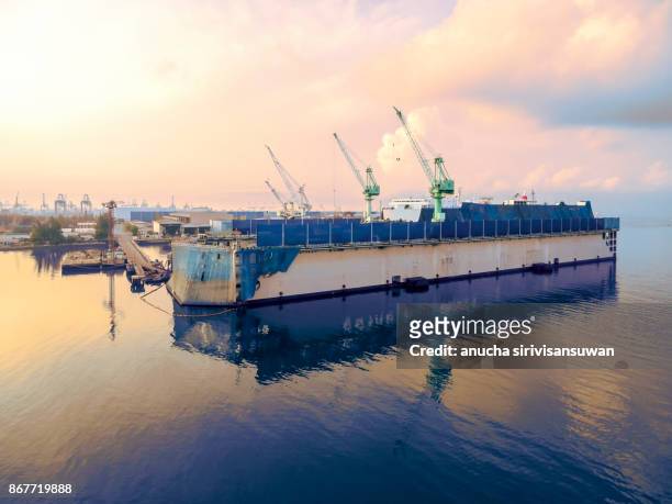 aerial view shipyard have crane machine and container ship in green sea . - elemento vasale foto e immagini stock
