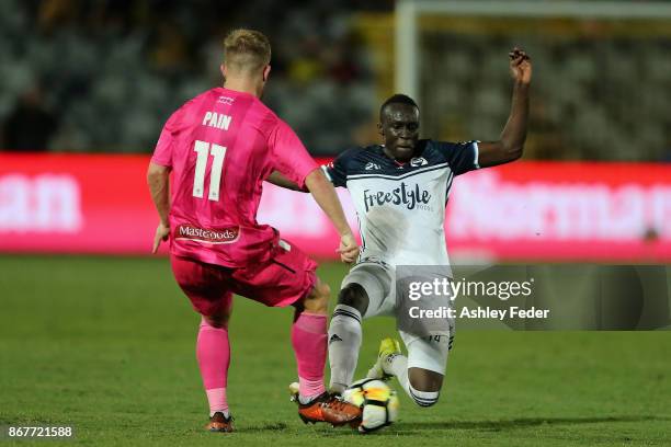 Thomas Deng of the Victory contests the ball against Connor Pain of the Mariners during the round four A-League match between the Central Coast...