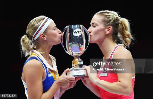 Andrea Hlavackova of Czech Republic and Timea Babos of Hungary kiss the Martina Navratilova trophy after victory in the Doubles Final against Johanna...