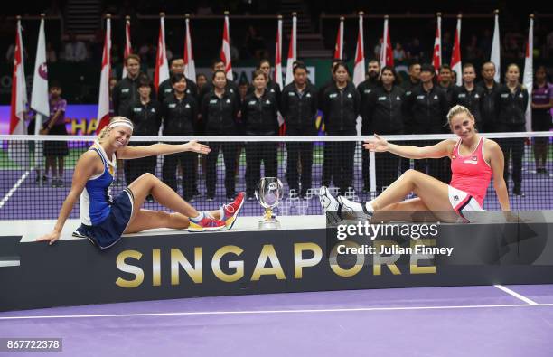 Andrea Hlavackova of Czech Republic and Timea Babos of Hungary pose with the Martina Navratilova trophy after victory in the Doubles Final against...