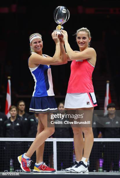 Andrea Hlavackova of Czech Republic and Timea Babos of Hungary pose with the Martina Navratilova trophy after victory in the Doubles Final against...