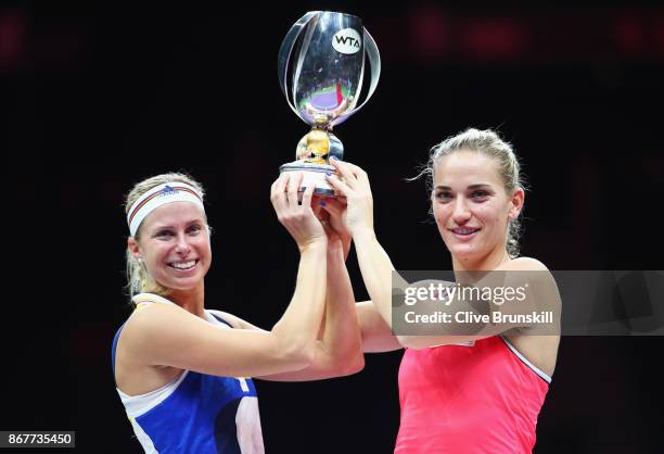 Andrea Hlavackova of Czech Republic and Timea Babos of Hungary pose with the Martina Navratilova trophy after victory in the Doubles Final against...