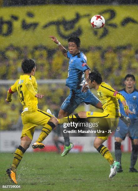 Takayuki Morimoto of Kawasaki Frontale competes for the ball against Kim Bo Kyung and Hajime Hosogai of Kashiwa Reysol during the J.League J1 match...