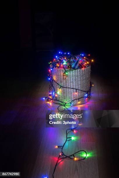 christmas ornament and light in basket - gift baskets stock pictures, royalty-free photos & images