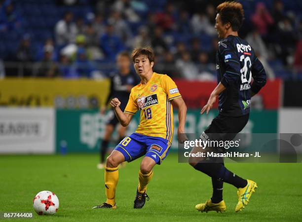 Hirotaka Mita of Vegalta Sendai takes on Shun Nagasawa of Gamba Osaka during the J.League J1 match between Gamba Osaka and Vegalta Sendai at Suita...
