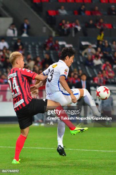Mu Kanazaki of Kashima Antlers controls the ball under pressure of Akito Fukumori of Consadole Sapporo during the J.League J1 match between Consadole...