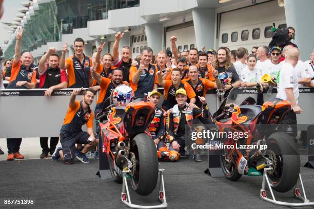 Miguel Oliveira of Portugal and Red Bull KTM Ajo and Brad Binder of South Africa and Red Bull KTM Ajo celebrates with team under the podium at the...