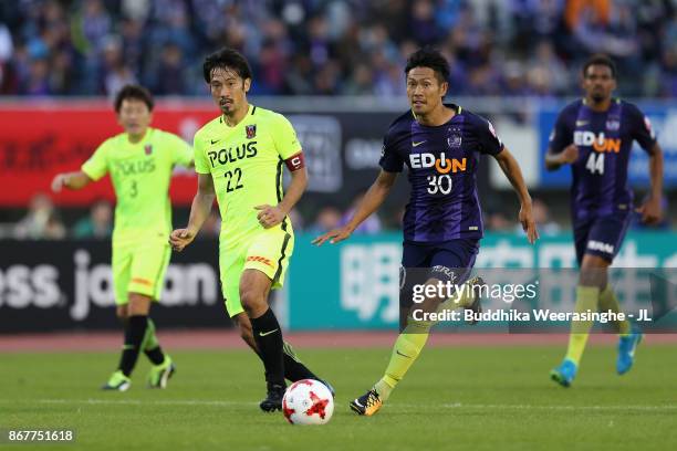 Yuki Abe of Urawa Red Diamonds and Kosei Shibasaki of Sanfrecce Hiroshima compete for the ball during the J.League J1 match between Sanfrecce...