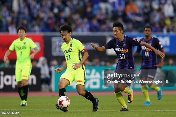 Yuki Abe of Urawa Red Diamonds and Kosei Shibasaki of Sanfrecce Hiroshima compete for the ball during the J.League J1 match between Sanfrecce...