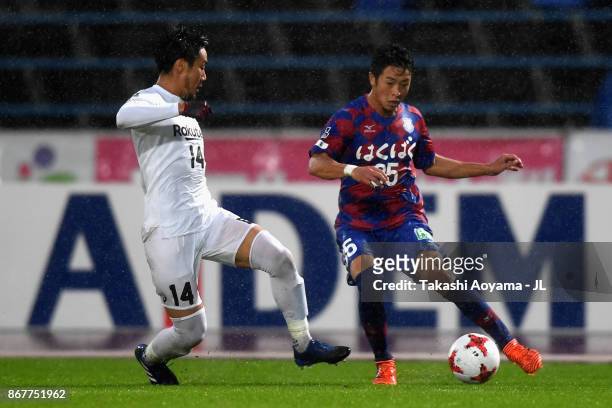 Ryo Takano of Ventforet Kofu takes on Naoyuki Fujita of Vissel Kobe during the J.League J1 match between Ventforet Kofu and Vissel Kobe at Yamanashi...