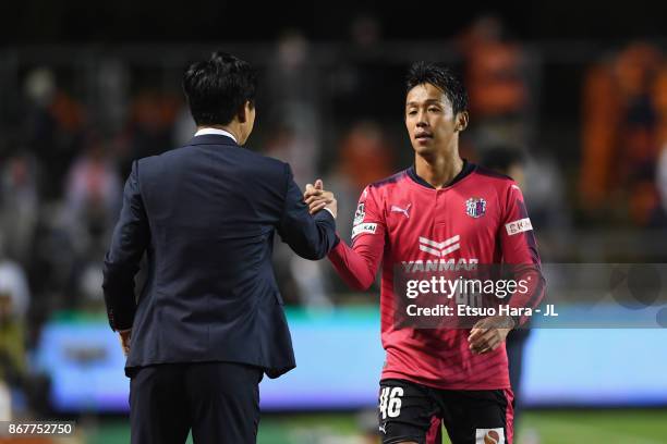 Hiroshi Kiyotake of Cerezo Osaka shakes hands with head coach Yoon Jung Hwan after substituted during the J.League J1 match between Cerezo Osaka and...