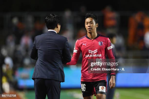 Hiroshi Kiyotake of Cerezo Osaka shakes hands with head coach Yoon Jung Hwan after substituted during the J.League J1 match between Cerezo Osaka and...