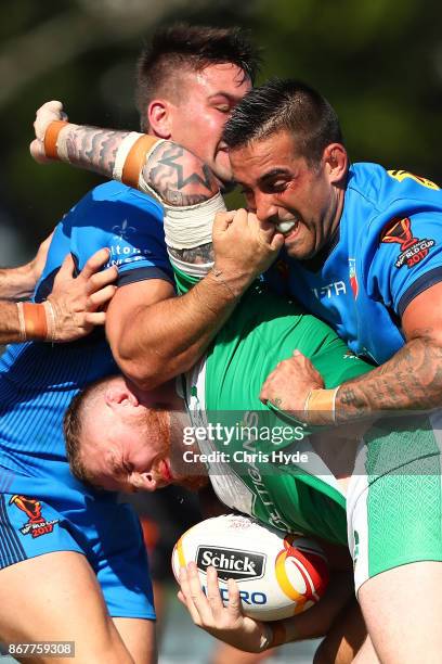 Brad Singleton of Ireland is tackled during the 2017 Rugby League World Cup match between Ireland and Italy at Barlow Park on October 29, 2017 in...