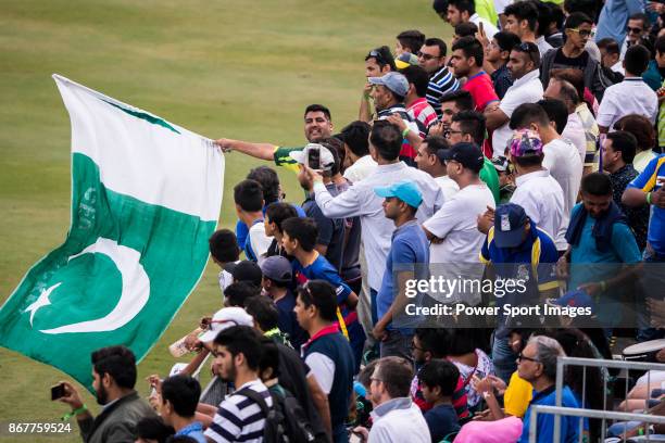 Fans of Pakistan team wave the national flag and show their supports during Day 2 of Hong Kong Cricket World Sixes 2017 Cup final match between...
