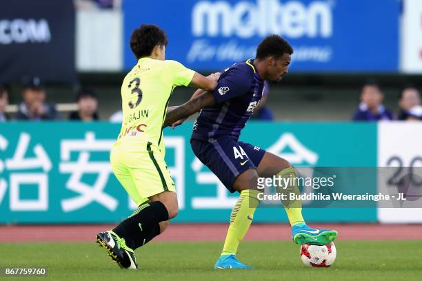 Anderson Lopes of Sanfrecce Hiroshima and Tomoya Ugajin of Urawa Red Diamonds compete for the ball during the J.League J1 match between Sanfrecce...