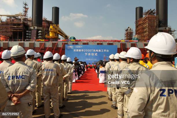 Chinese workers attends the launch ceremony of the world's largest offshore wind power operation platform Long Yuan Zhen Hua San Hao on August 28,...