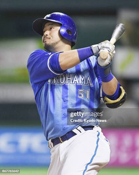 DeNA BayStars' Toshiro Miyazaki watches his two-run homer sail over the left fence in the sixth inning of Game 2 of the Japan Series against the...