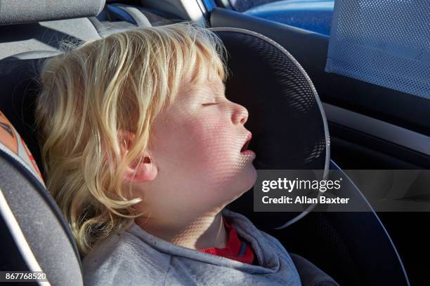 child asleep in car seat in hatchback car - carseat stock pictures, royalty-free photos & images