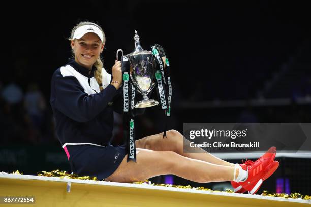 Caroline Wozniacki of Denmark celebrates victory with the Billie Jean King trophy in the Singles Final against Venus Williams of the United States...