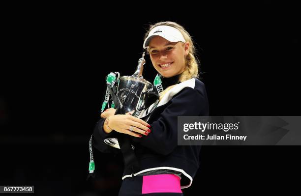 Caroline Wozniacki of Denmark celebrates victory with the Billie Jean King trophy in the Singles Final against Venus Williams of the United States...
