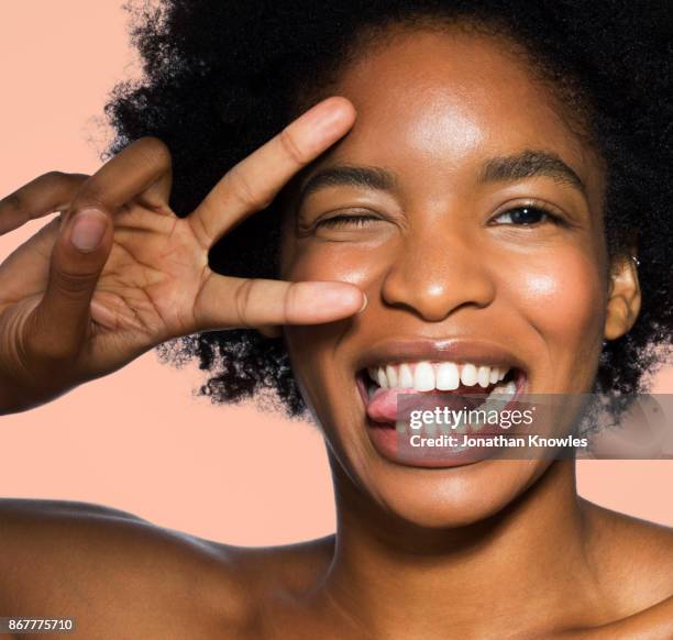 close-up of young female face - winking fotografías e imágenes de stock