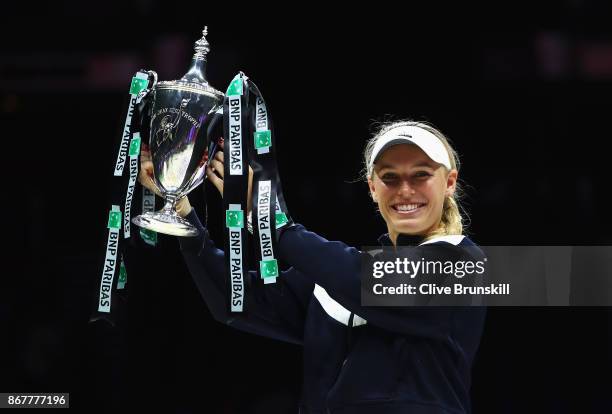 Caroline Wozniacki of Denmark celebrates victory with the Billie Jean King trophy in the Singles Final against Venus Williams of the United States...