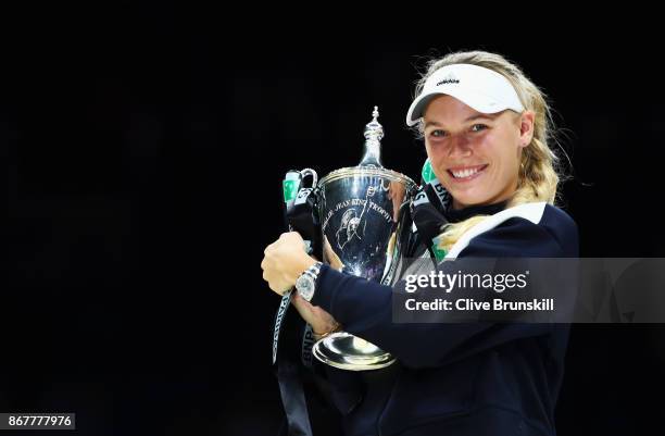 Caroline Wozniacki of Denmark celebrates victory with the Billie Jean King trophy in the Singles Final against Venus Williams of the United States...