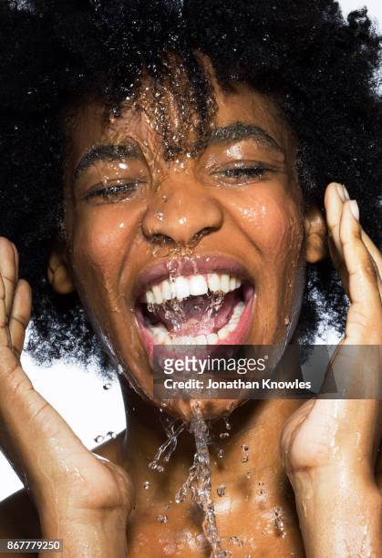 young female with water running down her face - woman face cleaning stock pictures, royalty-free photos & images