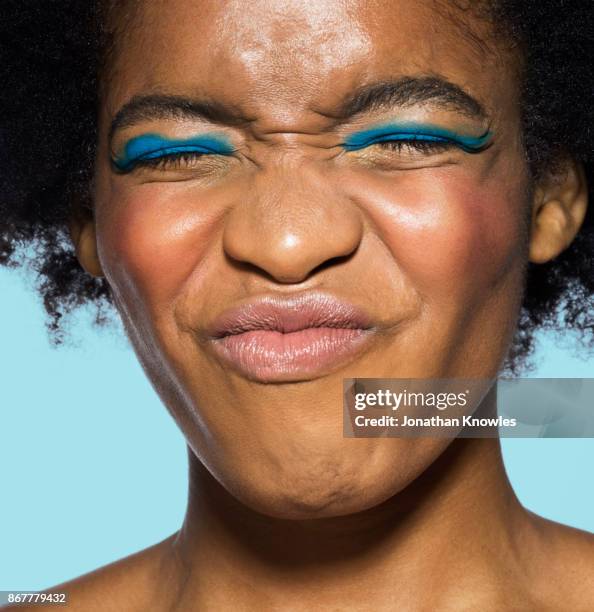 young female wrinkling face - pull a face stock pictures, royalty-free photos & images