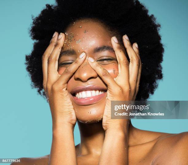 young female with glitter on her face - hands on face stock pictures, royalty-free photos & images