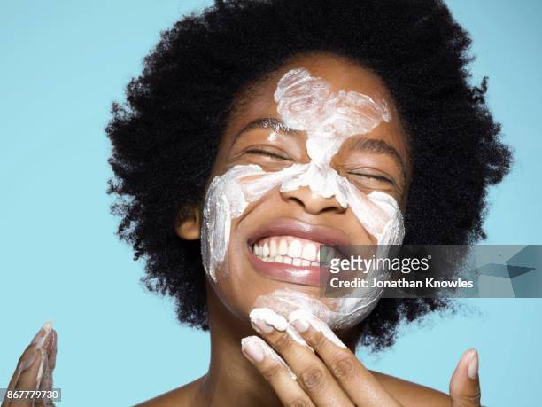 young female applying face cream / mask - spa treatment stock pictures, royalty-free photos & images