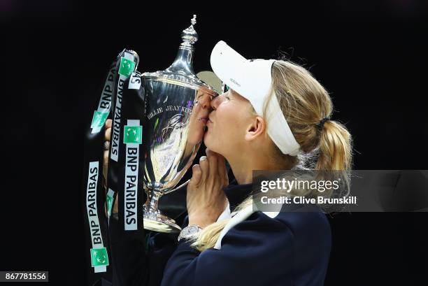 Caroline Wozniacki of Denmark celebrates victory with the Billie Jean King trophy in the Singles Final against Venus Williams of the United States...