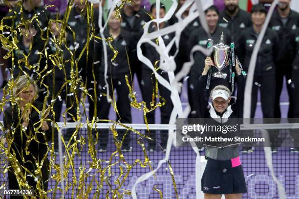 Caroline Wozniacki of Denmark celebrates victory with the Billie Jean King trophy in the Singles Final against Venus Williams of the United States...