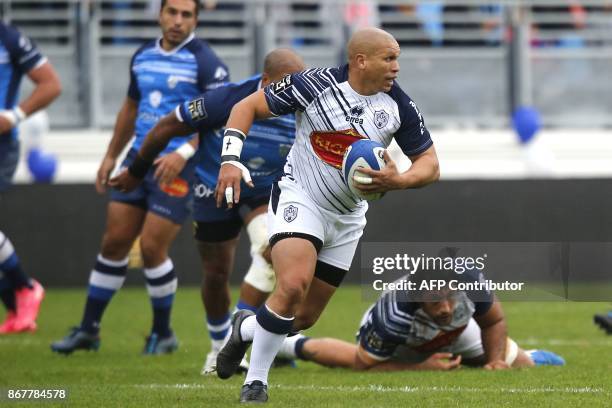 Agen's South African scrumhalf Enrico Januarie runs with the ball during the French Top 14 rugby union match between Castres and Agen, at the Pierre...