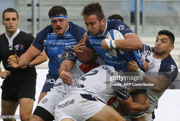 Castres' French flanker Anthony Jelonch is tackled by agen's hooker Facundo Bosch during the French Top 14 rugby union match between Castres and...