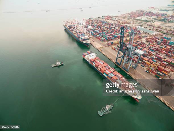 two tug boat towing cargo container in warehouse harbor at thailand . - elemento vasale foto e immagini stock