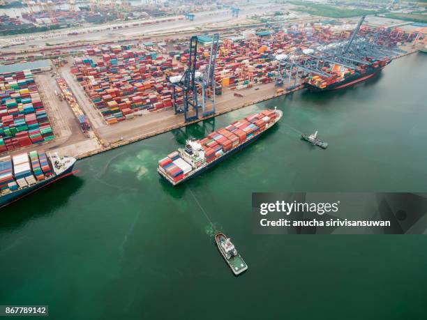 two tug boat towing cargo container in warehouse harbor at thailand . - elemento vasale foto e immagini stock