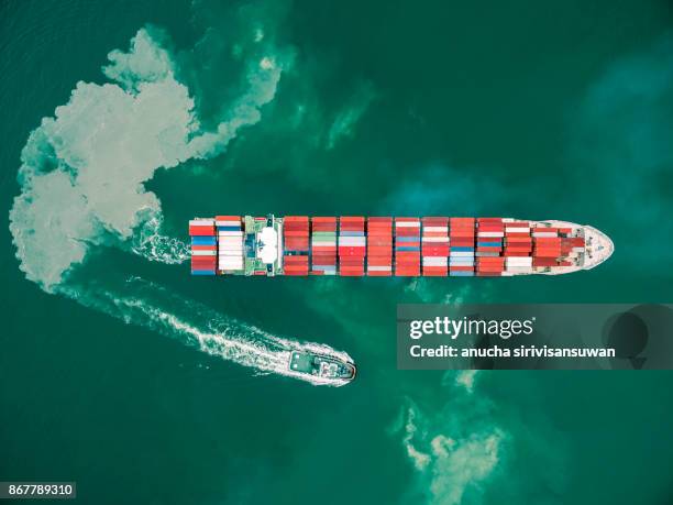 two tug boat towing cargo container in warehouse harbor at thailand . - elemento vasale foto e immagini stock