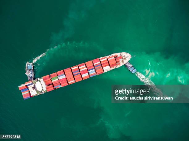 two tug boat towing cargo container in warehouse harbor at thailand . - elemento vasale foto e immagini stock