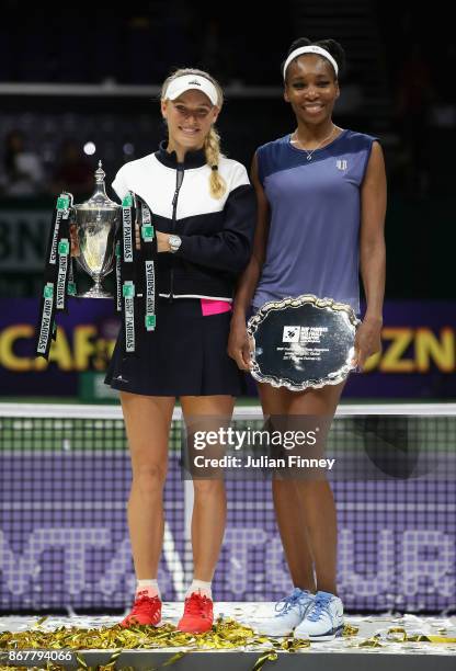 Winner Caroline Wozniacki of Denmark celebrates victory with the Billie Jean King trophy and runner up Venus Williams of the United States after the...