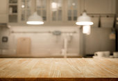 Wood table top on blur kitchen wall room background