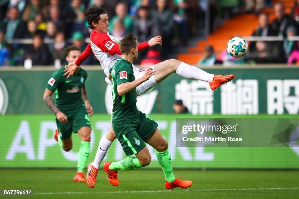 Niklas Moisander of Bremen and Michael Gregoritsch of Augsburg battle for the ball during the Bundesliga match between SV Werder Bremen and FC...