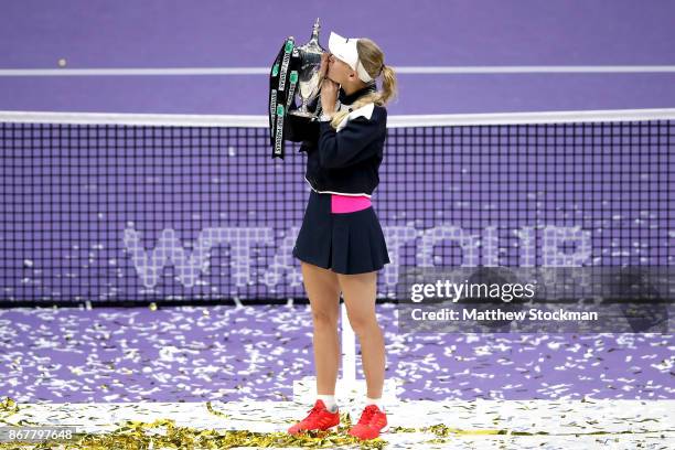 Caroline Wozniacki of Denmark celebrates victory with the Billie Jean King trophy in the Singles Final against Venus Williams of the United States...