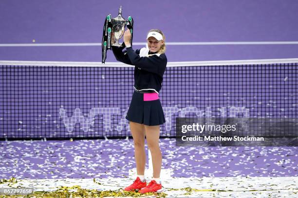 Caroline Wozniacki of Denmark celebrates victory with the Billie Jean King trophy in the Singles Final against Venus Williams of the United States...