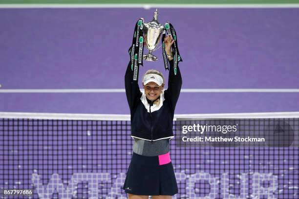 Caroline Wozniacki of Denmark celebrates victory with the Billie Jean King trophy in the Singles Final against Venus Williams of the United States...