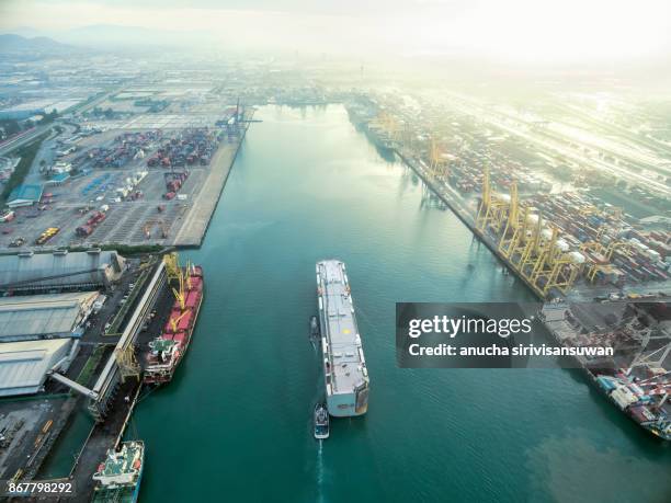 two tug boat towing cargo container in warehouse harbor at thailand . - elemento vasale foto e immagini stock